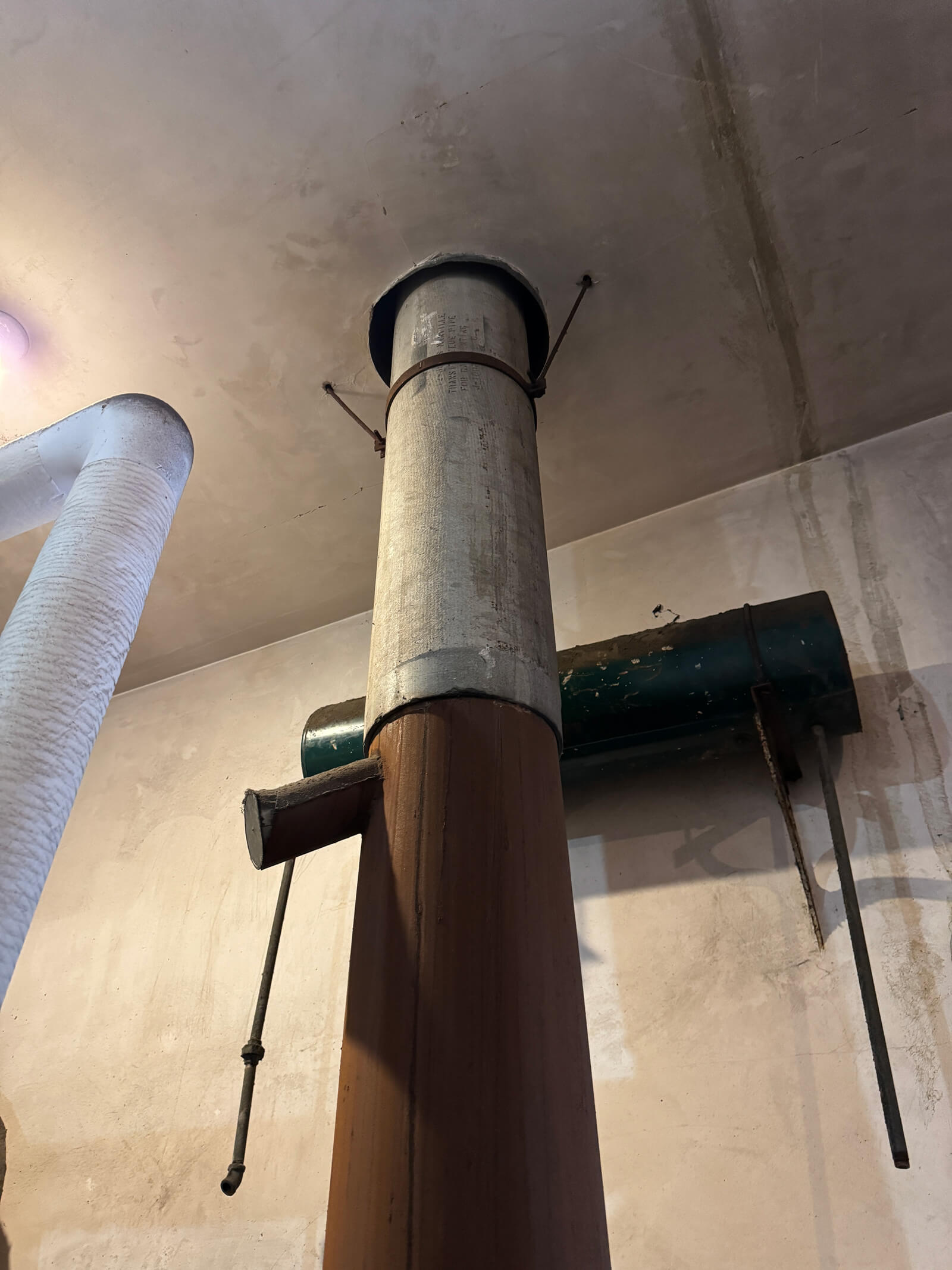 Industrial pipes inspected during a professional hazardous material survey to identify potential asbestos.