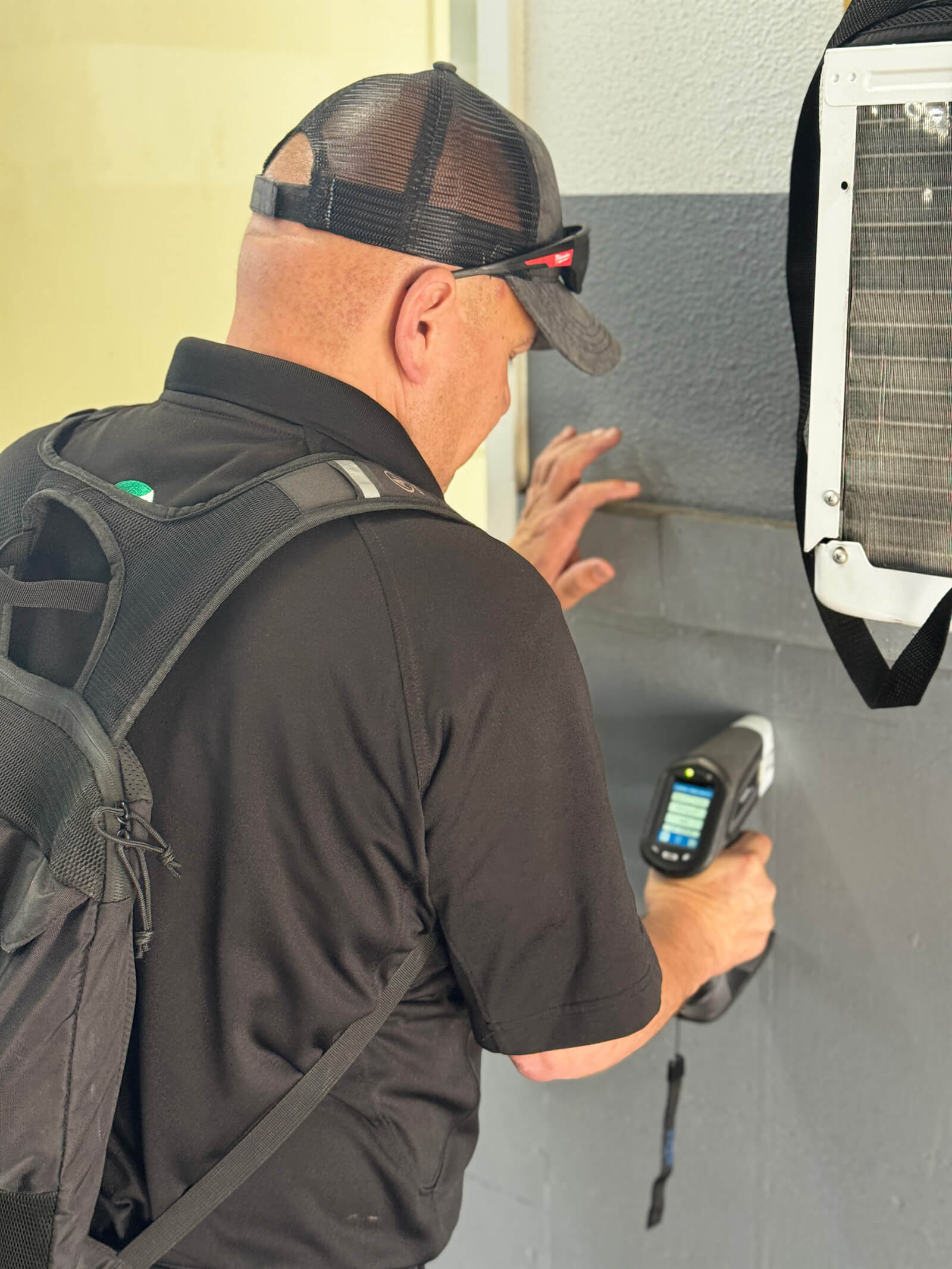 Vert Environmental specialist checking a wall surface for lead-based paint using XRF technology.