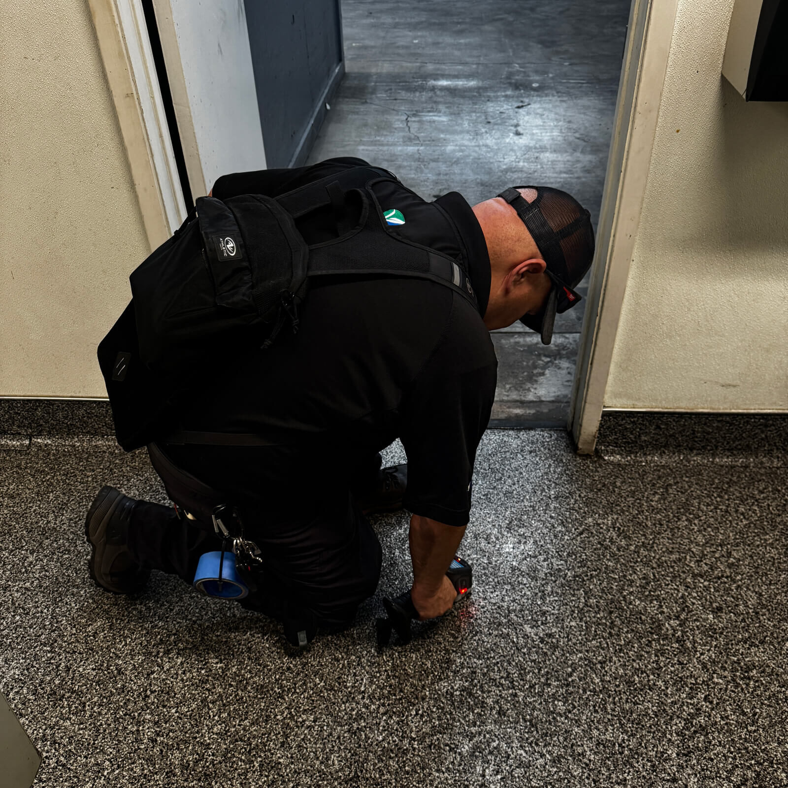 Vert Environmental professional conducting XRF surface testing for lead on flooring.